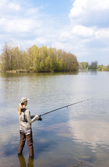 woman fishing in pond