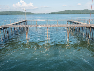Floating fish basket with blue sea water and sky cloud