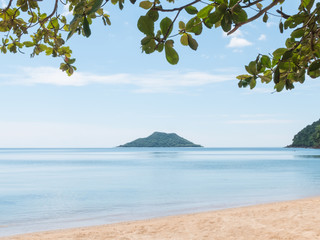 Fototapeta premium Island located on the sea with tree leaf foreground and copy spa