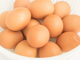 Fresh raw egg from organic farm in the plastic basket isolated o