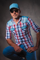 senior trucker resting on a chair in studio