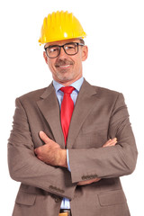 happy construction engineer standing with hands crossed