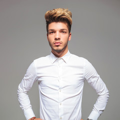 attractive young man in casual shirt with hands on waist
