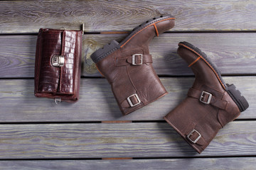 Men's shoes and a brown leather purse.