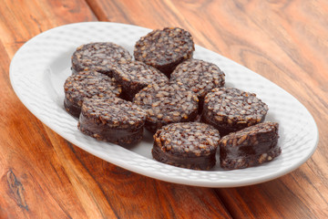 Iberian homemade sausage on white tray