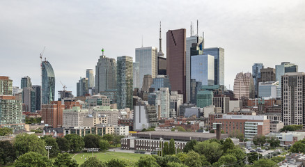 Fototapeta na wymiar Evening view from a high-rise building of Moss Park Arena with nearby buildings,Toronto's Financial District skyscrapers and CN Tower apex at the background.