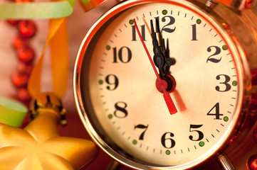 watch hands by 12 hours and Christmas toys background closeup