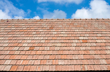 Roof tiles and blue sky with clouds