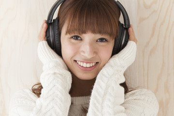 Young women are wearing wireless headphones