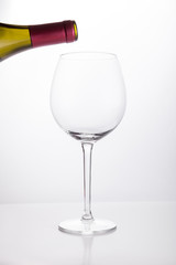 White wine pouring in a glass from bottle