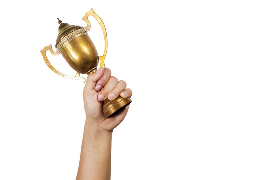 Holding the cup with white background.Conceptual of winning.
