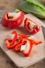 Slice bell pepper on wood cutting board. Selective focus.