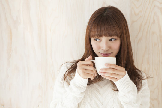 Young women are drinking hot coffee