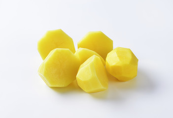 Halved peeled potatoes