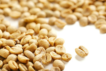Green Coffee Beans on White Table.