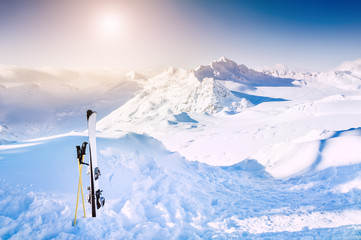 Winter mountains and ski equipment in the snow