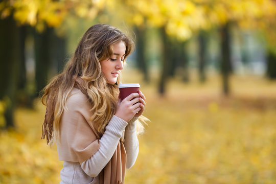Teenage girl with cup of coffee