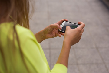 Close up of smartphone holding by young businesswoman.