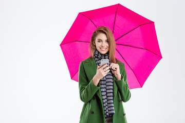 Woman holding smartphone under umbrella