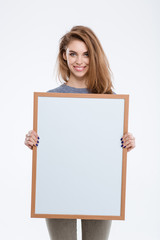 Smiling woman showing blank board