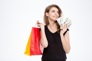 Happy woman holding shopping bags and money