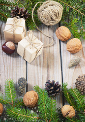 toys for the Christmas tree and pine cones on old wooden background