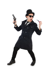 Young detective in black coat holding handgun isolated on white