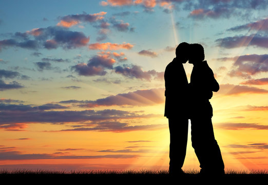 Silhouette of two gay men kissing