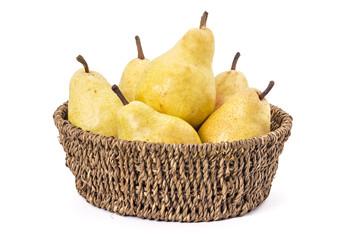 Juicy ripe pears in woven basket, on a white background