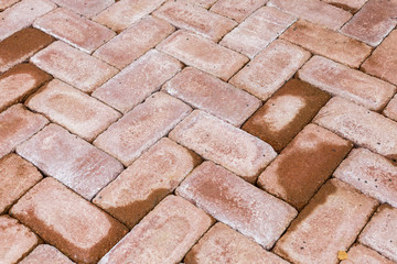 Red brick paving stones on a sidewalk