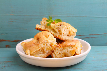 homemade apple pie (charlotte) on a blue wooden background