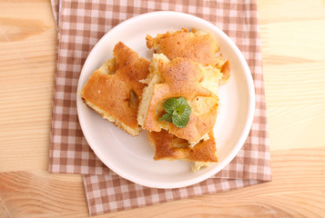 homemade apple pie (charlotte) on a blue wooden background spruce branches