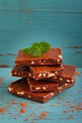 pieces of milk chocolate with nuts decorated with mint