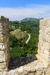 Fototapeta na wymiar Country curvy road seen from Angelokastro walls, Corfu, Greece.