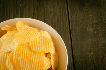 potato chips on wood - soft focus with vintage film filter