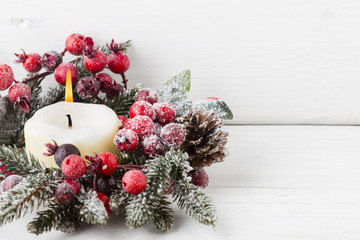 Christmas decoration with fir branches on the wood background.