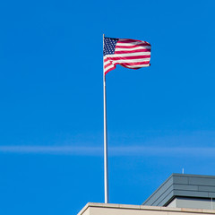  the American flag on top of the US Embassy in Berlin.