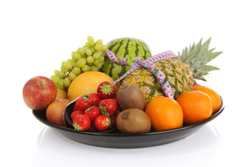 Naklejka na ściany i meble Big plate with lots of healthy fruits andmeasure tape