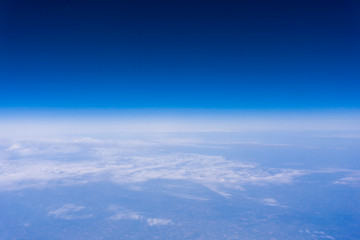 Naklejka na ściany i meble Skyline View above the Clouds from air plane. Sky background