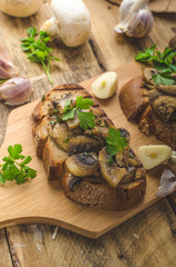 Mushroom mixture on rustic toast with garlic