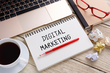 Digital marketing handwriting note with laptop on work desk