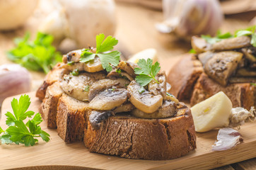 Mushroom mixture on rustic toast with garlic