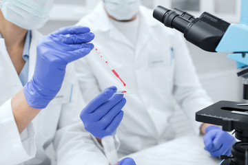 close up of scientists filling perti dish in lab