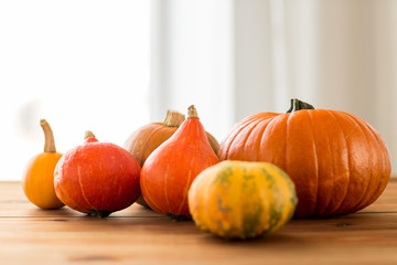 close up of pumpkins on wooden table at home