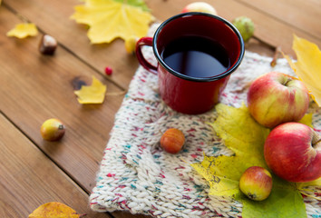 close up of tea cup on table with autumn leaves