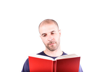 Young man reading a red book