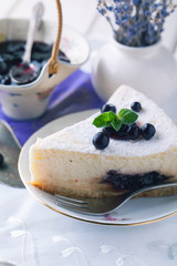 Cheesecake with currant and mint leaf