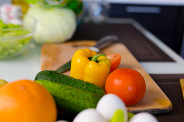 Yellow pepper and cucumbers background