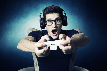 videogame addicted young guy playing with console 
