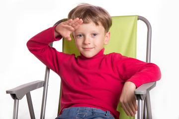 The boy sat in an armchair a picture close up